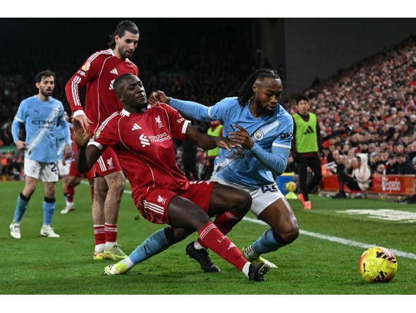 Manchester City's Ghanaian midfielder #42 Antoine Semenyo (R) fouls Liverpool's French defender #05 Ibrahima Konate (front L) which results in a free kick during the English Premier League football match between Liverpool and Manchester City at Anfield in Liverpool, on February 8, 2026. (Photo by Paul ELLIS / AFP)