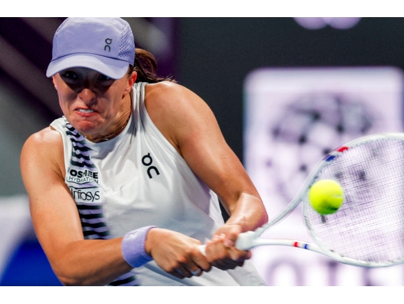 Poland's Iga Swiatek returns a shot during her women’s singles quarter-final match against Greece's Maria Sakkari at the Qatar Open tennis tournament in Doha on February 12, 2026. (Photo by Karim Jaafar / AFP)
