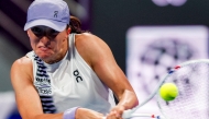 Poland's Iga Swiatek returns a shot during her women’s singles quarter-final match against Greece's Maria Sakkari at the Qatar Open tennis tournament in Doha on February 12, 2026. (Photo by Karim Jaafar / AFP)
