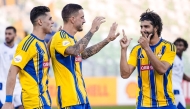 Al Gharafa’s Joselu (centre) celebrates with teammates.  
