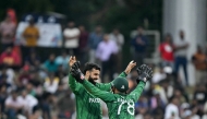 Pakistan's Shadab Khan (L) celebrates with wicketkeeper Usman Khan after taking the wicket of Namibia's Alexander Busing-Volschenk in Colombo on February 18, 2026. (Photo by Ishara S. Kodikara / AFP)