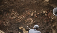 This handout picture released by Panama Ministry of Culture shows an archaeologist working inside a pre-Hispanic tomb approximately 1,200 years old, discovered at the El Cano Archaeological Park in Cocle, panama, on February 20, 2026. (Photo by Handout / panama / AFP)