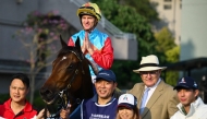 Ka Ying Rising with jockey Zac Purton and trainer David Hayes (2nd R) pose with others after victory in the Queen's Silver Jubilee Cup horse race at Sha Tin Racecourse in Hong Kong on February 22, 2026. (Photo by Peter Parks / AFP)