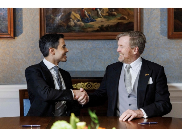 Netherlands' King Willem-Alexander (R) shakes hands with Prime Minister Rob Jetten during the signing of the Royal Decrees in the Meeting Room at Huis ten Bosch Palace for the swearing-in ceremony of the new cabinet in The Hague, The Netherlands on February 23, 2026. (Photo by Koen van Weel / ANP / AFP)
