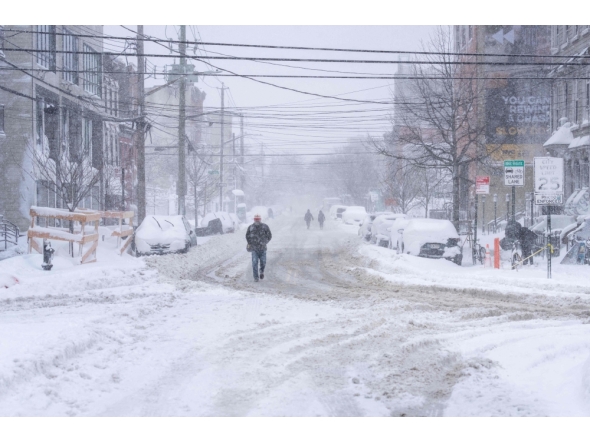 A person trudges through heavy snow on February 23, 2026 in the Brooklyn borough of New York City. Jeremy Weine/Getty Images/AFP