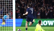 Paris Saint-Germain's Georgian forward #07 Khvicha Kvaratskhelia (L) celebrates after scoring Paris Saint-Germain's second goal during the UEFA Champions League play-off second leg football match between Paris Saint-Germain (PSG) and AS Monaco at the Parc des Princes stadium in Paris on February 25, 2026. (Photo by FRANCK FIFE / AFP)