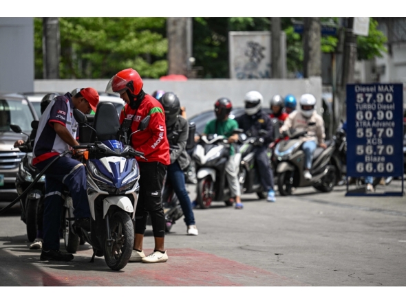 Motorists queue at a gas station amid rising petrol prices in Quezon City, Metro Manila on March 9, 2026. (Photo by Jam Sta Rosa / AFP)