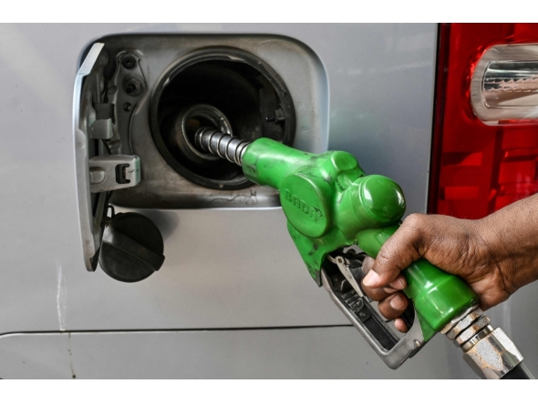 A worker refuels a car at a filling station in Dhaka on March 9, 2026. (Photo by Munir Uz Zaman / AFP)