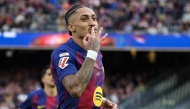 Barcelona's Brazilian forward #11 Raphinha celebrates scoring his team's fourth goal and his hat-tick, during the Spanish League football match between FC Barcelona and Sevilla FC at the Camp Nou Stadium in Barcelona, on March 15, 2026. (Photo by Lluis GENE / AFP)
