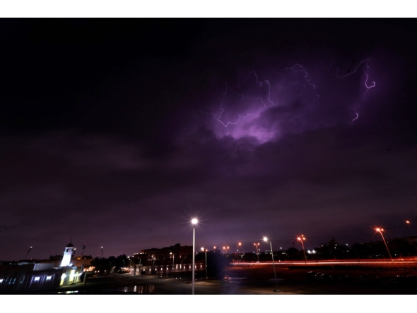 Lightning streaks across the sky during a thunderstorm over Doha on March 25, 2026. Photo by Karim JAAFAR / AFP