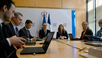 France's Economy and Finance Minister Roland Lescure (C-L) and France's Government Spokesperson and Energy Minister Maud Bregeon (C-R) sit moments before hosting a videoconference with the G7 energy and finance ministers with central banks representatives at the French Economy minister in Paris on March 30, 2026. (Photo by Anna KURTH / AFP)