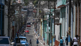 People walk down a street in Matanzas, Cuba, on March 31, 2026. (Photo by Yamil Lage / AFP)