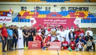 Qatar Basketball Federation President Mohammed bin Saad Al Mughaisib presents the trophy. 
