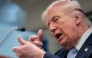 US President Donald Trump mimics firing a gun as he speaks about the conflict in Iran in the James S. Brady Press Briefing Room of the White House on April 6, 2026, in Washington, DC. (Photo by Kent Nishimura / AFP)