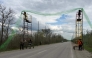 Ukrainian servicemen cover the road with a net to protect vehicles from drone attacks at an undisclosed location in the Zaporizhzhia region on April 10, 2026. (Photo by Darya Nazarova / AFP)