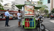 A man sells the popular breakfast roll 'pandesal' in Manila on April 7, 2026. (Photo by Jam Sta Rosa / AFP)