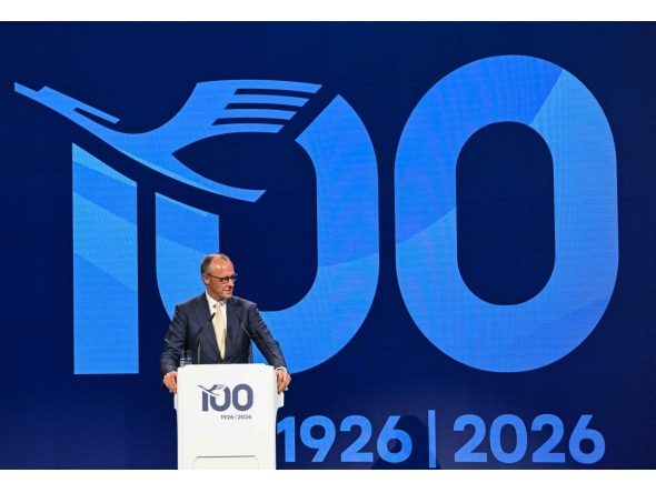 German Chancellor Friedrich Merz delivers a speech during a ceremony to celebrate the 100th anniversary of the founding of the first Lufthansa at Lufthansa Group Hangar One, Frankfurt Aiport, in Frankfurt am Main, western Germany on April 15, 2026. (Photo by Kirill KUDRYAVTSEV / AFP)