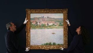 (FILES) Employees of the Sotheby's auction house handle the painting 