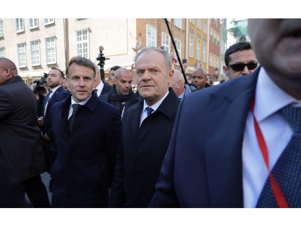 French President Emmanuel Macron (L) and Poland's Prime Minister Donald Tusk walk through Gdansk on April 20, 2026, during Macron's one-day-visit to Poland. (Photo by Ludovic MARIN / AFP)