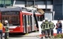 Firefighters and rescue personnel stand next to a trolleybus that crashed into a supermarket on April 20, 2026 in Salzburg, Austria. (Photo by various sources / AFP) 