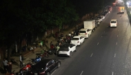 People queue up along a road, to refuel their vehicles at a filling station in Dhaka on April 21, 2026. (Photo by MUNIR UZ ZAMAN / AFP)
