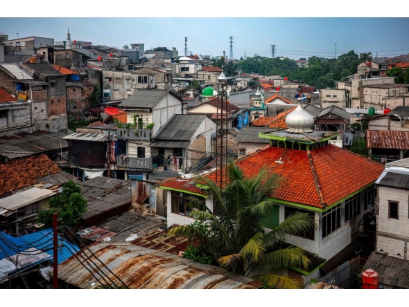 Houses are seen in a densely populated neighbourhood in Jakarta on April 21, 2026. (Photo by BAY ISMOYO / AFP)