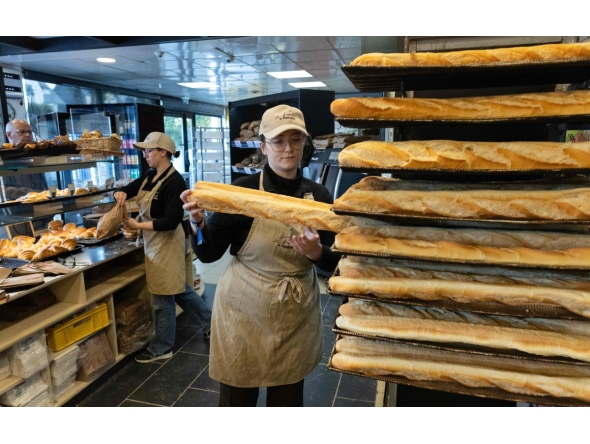 An employee works in a bakery in Quimper, western France, on May 1, 2026. Photo by Fred TANNEAU / AFP