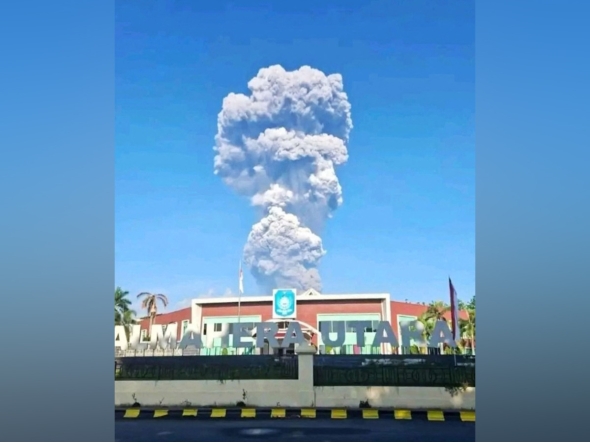 A handout picture taken and released by Indonesia's disaster mitigation agency (BNPB) on May 8, 2026, shows smoke rising from the eruption of Mount Dukono as seen from Tobelo, North Maluku. AFP PHOTO / Indonesia DISASTER MITIGATION AGENCY
