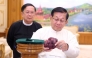 This handout photo taken and released on May 7, 2026 by Myanmar Radio and Television (MRTV) shows Myanmar president Min Aung Hlaing (R) holding an 11,000-carat ruby in Naypyidaw, after it was found at a gem tract in Mogok in Mandalay Region.  (Photo by Handout / Myanmar Radio and Television / AFP) /