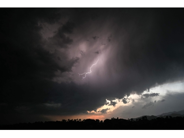 A general view shows the Himalayas' Dhauladhar mountain range as lightning strikes across the sky above Dharamsala on May 13, 2026. (Photo by Sajjad HUSSAIN / AFP)