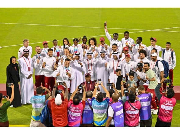 Qatar Athletics Federation President Mohammed Issa Al-Fadala celebrates with Team Qatar's medal winners.