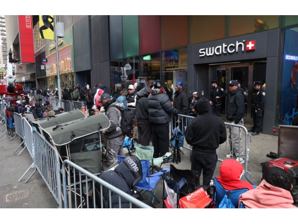 This photo taken on May 15, 2026, shows people camping out in line outside of the Swatch store in Times Square in New York, ahead of the May 16 release of the Audemars Piguet x Swatch Royal Pop watch. Photo by Timothy A. Clary / AFP
