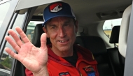 British climber Kenton Cool waves from a car upon his arrival at the airport in Kathmandu. (Photo by Prakash Mathema / AFP)