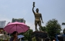 Commuters walk past a statue of Argentine football player Lionel Messi in Kolkata on May 27, 2026. (Photo by Dibyangshu Sarkar / AFP)