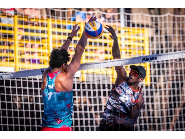 Qatar's Ahmed Tijan (right) shoots to score a point.