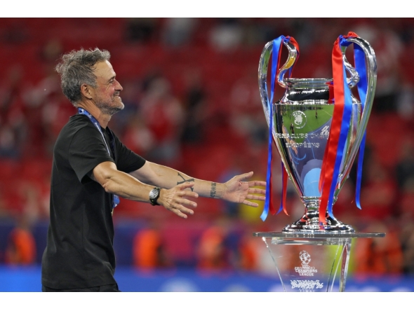 Paris Saint-Germain's Spanish head coach Luis Enrique walks to hug the trophy after winning the UEFA Champions League final football match between Paris Saint-Germain (PSG) and Arsenal FC at the Puskas Arena in Budapest on May 30, 2026. (Photo by Odd Andersen / AFP)