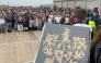 The O'Sullivan clan family crest is held by a participant in a bid to break a world record for the largest gathering of people with the same surname, in Castletownbere, Ireland, on May 30, 2026. (Photo by Peter Murphy / AFP)