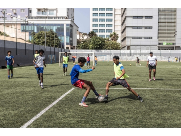 (Files) Football students play a game during practice at the Bola Pra Frente (Ball Forward) football academy in Praia, on May 18, 2026. (Photo by Patrick Meinhardt / AFP)