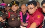 Dadan Hindayana (C), former head of Indonesia's free school meals programme, is escorted by officers from the Attorney General's Office and Indonesian military personnel as he leaves the Attorney General's Office building in Jakarta on June 3, 2026, following questioning over alleged misappropriation in the implementation of the programme. Photo by Diyah Nasution / AFP