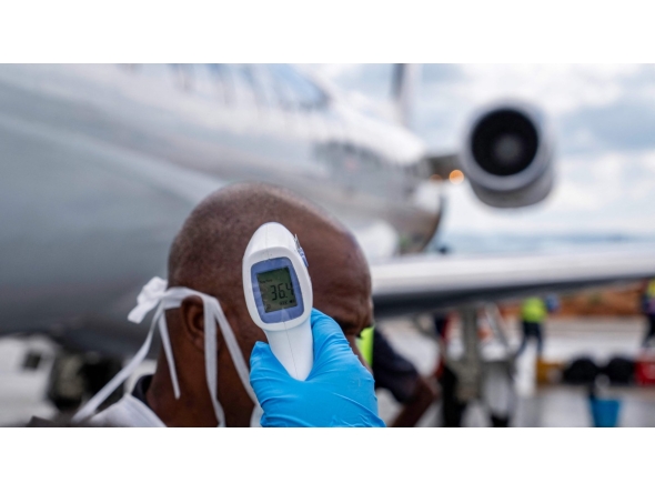 A passenger's temperature is checked at Bunia Airport in eastern Democratic Republic of the Congo on June 3, 2026. Photo by GLODY MURHABAZI / AFP