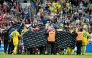 Denmark's and Ukraine's players huddle to accompany Christian Eriksen to a waiting ambulance during the football international friendly match between Denmark and Ukraine at Odense Stadium in Denmark, on June 7, 2026.  (Photo by Bo Amstrup / Ritzau Scanpix / AFP) / Denmark OUT