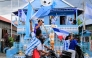 Argentina fan and fisherman Muhammad Yusuf (back C) holds a replica of the World Cup trophy as football fans pass his house, painted in the colours of the Argentine national team in Indonesia's West Sulawesi on June 11, 2026. (Photo by Muhammad Salim / AFP)