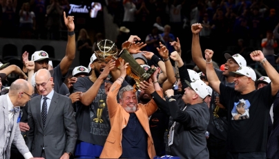 New York Knicks owner James Dolan lifts the Larry O'Brien Championship Trophy after his team defeated the San Antonio Spurs in Game Five of the 2026 NBA Finals at Frost Bank Center on June 13, 2026 in San Antonio, Texas. Gregory Shamus/Getty Images/AFP (Photo by Gregory Shamus / GETTY IMAGES NORTH AMERICA / Getty Images via AFP)