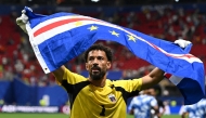 Cape Verde's goalkeeper #01 Vozinha celebrates with his national flag at the end of the 2026 World Cup Group H football match between Spain and Cape Verde at the Atlanta Stadium in Atlanta on June 15, 2026. (Photo by ROBERTO SCHMIDT / AFP)