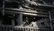 A man looks out from a damaged apartment building following an earthquake in Catia La Mar, La Guaira state, some 30km north-west of Caracas, on June 25, 2026. Photo by FEDERICO PARRA / AFP