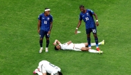 Abdulelah Al-Amri #4 and Ali Lajami #3 of Saudi Arabia react after the 0-0 draw during the FIFA World Cup 2026 Group H match between Cabo Verde and Saudi Arabia at Houston Stadium on June 26, 2026 in Houston, Texas. Charlotte Wilson/Getty Images/AFP