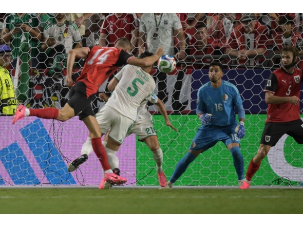 Austria's forward #14 Sasa Kalajdzic heads the ball to score his team's third goal. (Photo by Juan Mabromata / AFP)