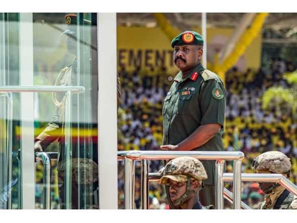 (Files) Muhoozi Kainerugaba (C), son of Yoweri Museveni and Uganda's Chief of Defence Forces, inspects a military parade on May 12, 2026. (Photo by Badru Katumba / AFP)