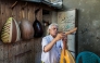 Displaced Palestinian craftsman Suhail Abu Shawish tunes a Oud musical instrument at his makeshift workshop in the Nuseirat camp for Palestinian refugees in the central Gaza Strip on June 23, 2026. (Photo by Eyad Baba / AFP)