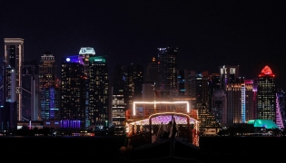 Illuminated skyscrapers are pictured along the corniche promenade in Doha on June 29, 2026. (Photo by Karim Jaafar / AFP)
